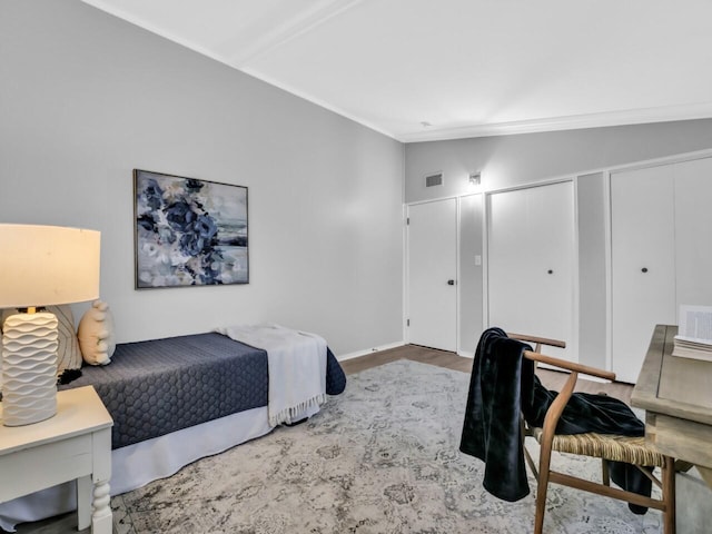 bedroom featuring hardwood / wood-style flooring and vaulted ceiling