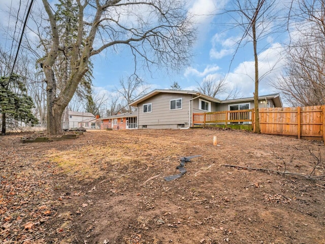 rear view of property featuring a deck