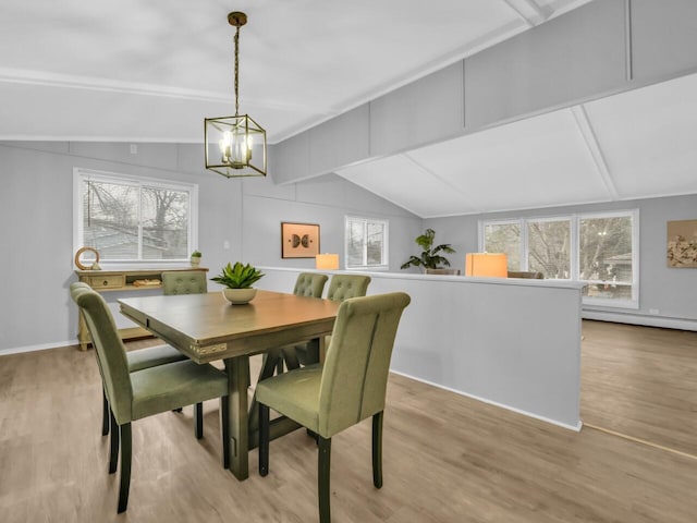 dining space featuring lofted ceiling, light hardwood / wood-style flooring, a baseboard radiator, and an inviting chandelier