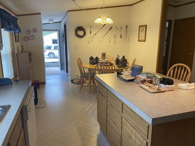 kitchen with hanging light fixtures, ornamental molding, and a chandelier