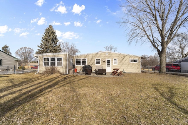 back of house with cooling unit, a yard, and a patio area