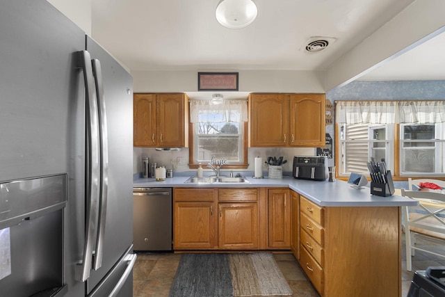 kitchen with stainless steel appliances, sink, and kitchen peninsula