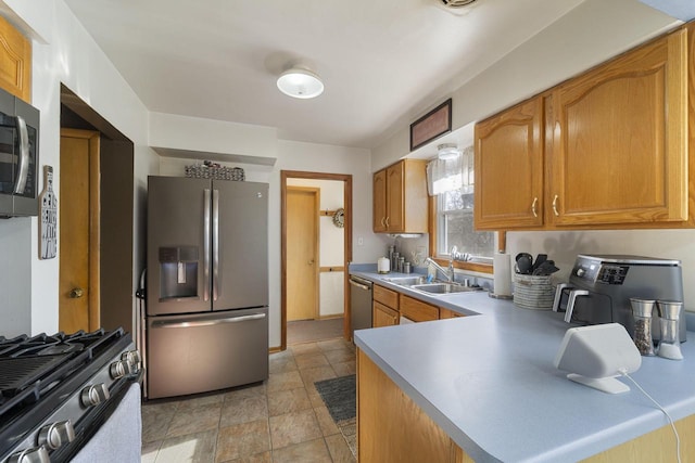 kitchen with stainless steel appliances, kitchen peninsula, and sink