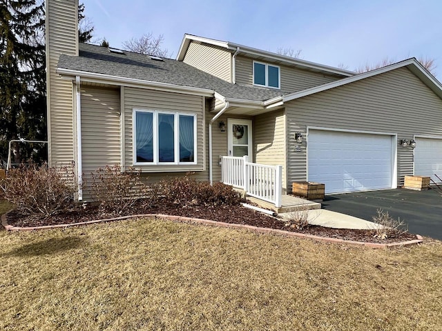 view of front of house featuring a garage and a front yard