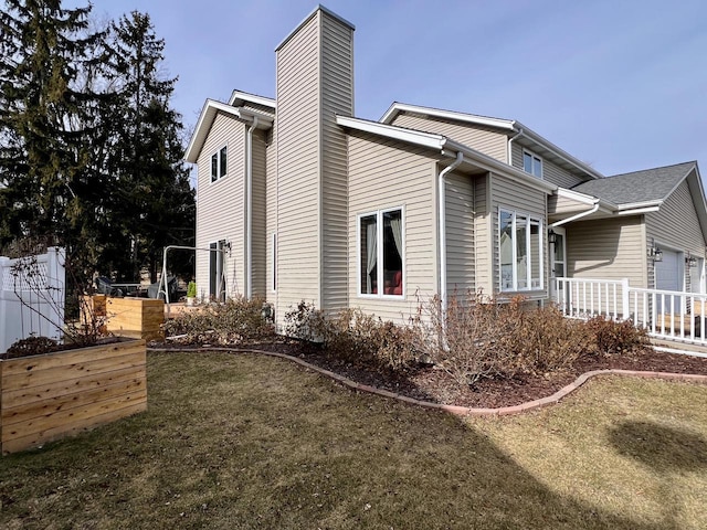 view of side of property with a yard