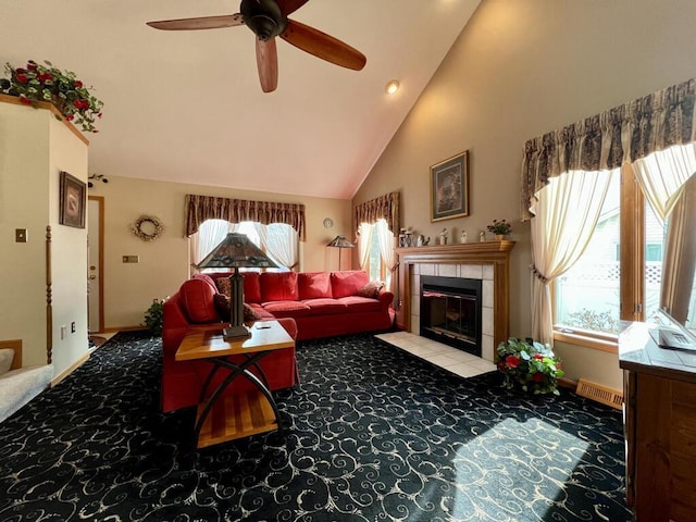 living room featuring ceiling fan, high vaulted ceiling, light colored carpet, and a fireplace