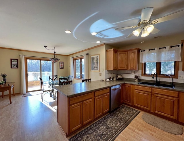 kitchen with dishwasher, sink, hanging light fixtures, light hardwood / wood-style floors, and kitchen peninsula