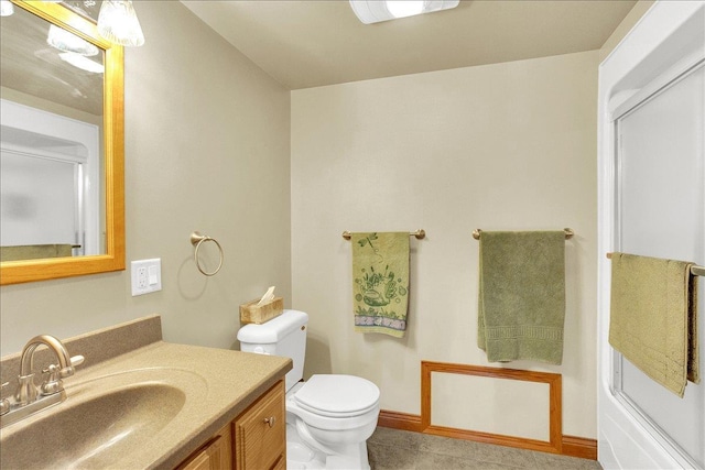 bathroom with tile patterned flooring, toilet, vanity, and walk in shower