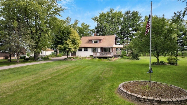 view of front of home featuring a wooden deck and a front yard