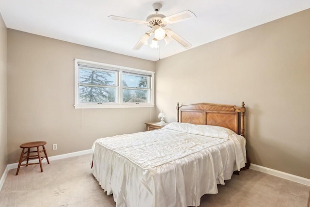 bedroom with ceiling fan and light carpet