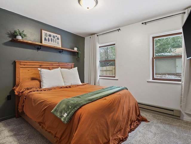 bedroom with baseboard heating and carpet floors