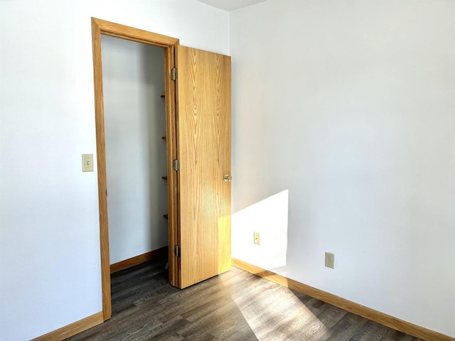 unfurnished bedroom with dark wood-type flooring