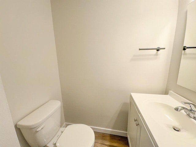 bathroom with vanity, hardwood / wood-style floors, and toilet