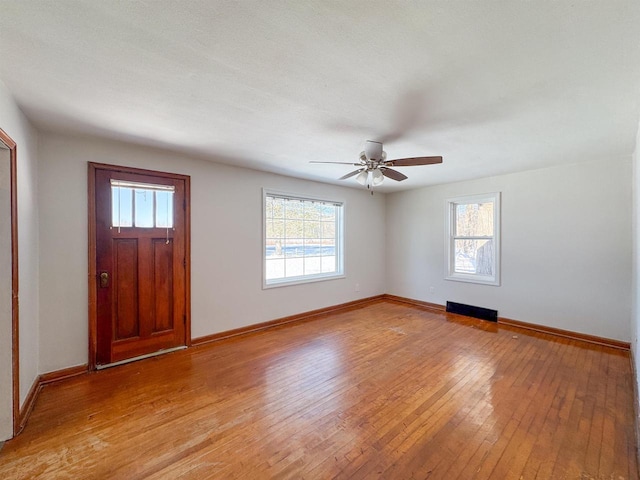 foyer with ceiling fan and light hardwood / wood-style floors