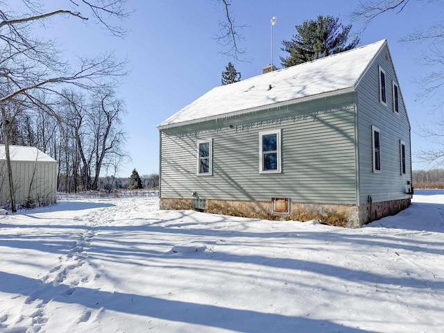 view of snow covered rear of property