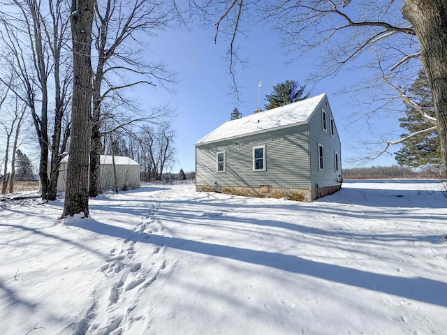 view of snow covered rear of property