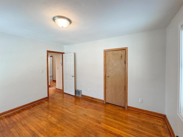 spare room with light hardwood / wood-style flooring