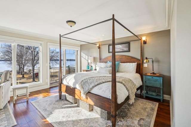 bedroom featuring dark hardwood / wood-style flooring, crown molding, and access to outside