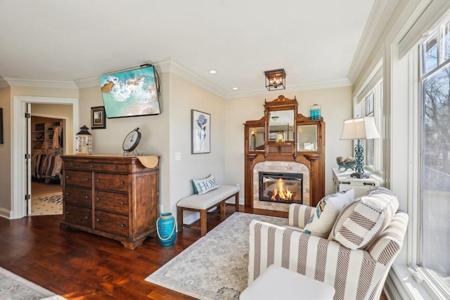 sitting room with dark hardwood / wood-style flooring and ornamental molding