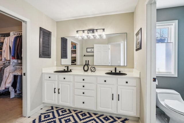 bathroom featuring vanity, toilet, and tile patterned flooring