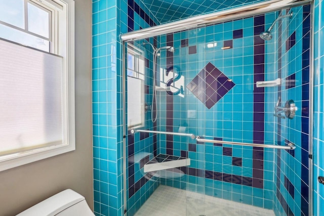 bathroom featuring an enclosed shower and toilet