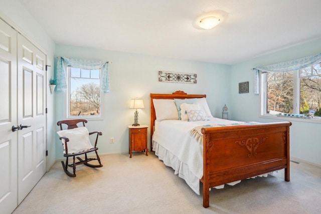 carpeted bedroom with a closet