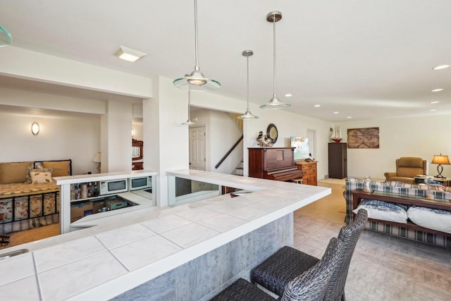 kitchen featuring a kitchen breakfast bar and decorative light fixtures