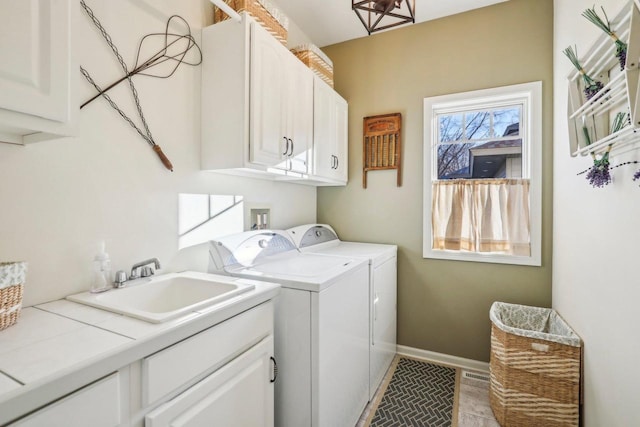 washroom featuring cabinets, separate washer and dryer, and sink