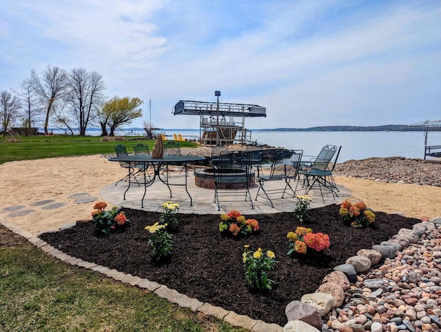 view of patio / terrace with a fire pit and a water view