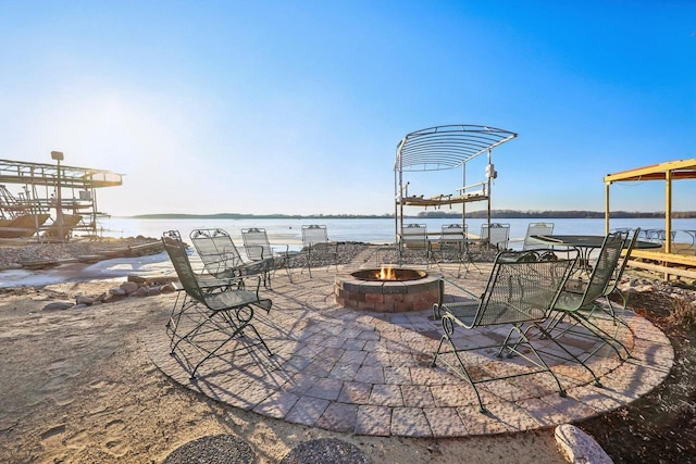 view of patio / terrace with a water view and an outdoor fire pit