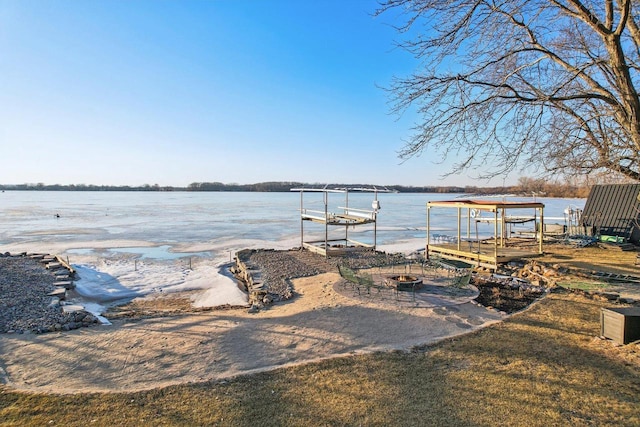 dock area featuring a water view and an outdoor fire pit