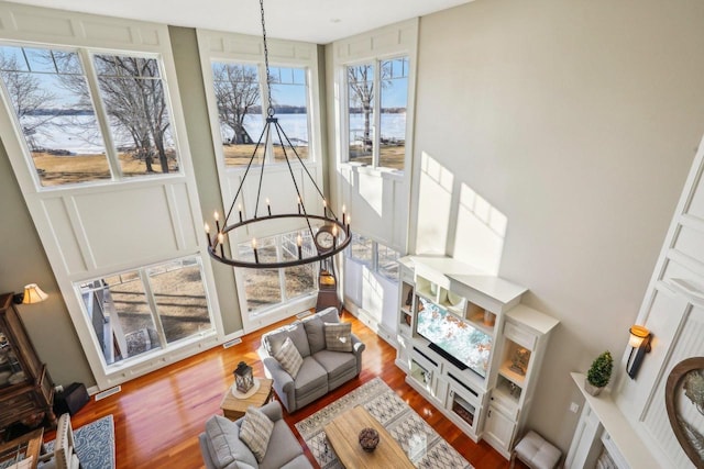 living room featuring hardwood / wood-style floors and an inviting chandelier