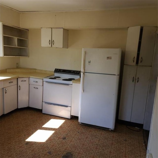 kitchen featuring white cabinetry and white appliances