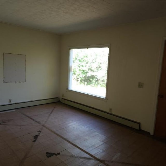 spare room featuring a baseboard heating unit