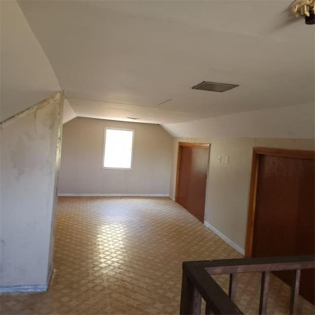 additional living space featuring vaulted ceiling