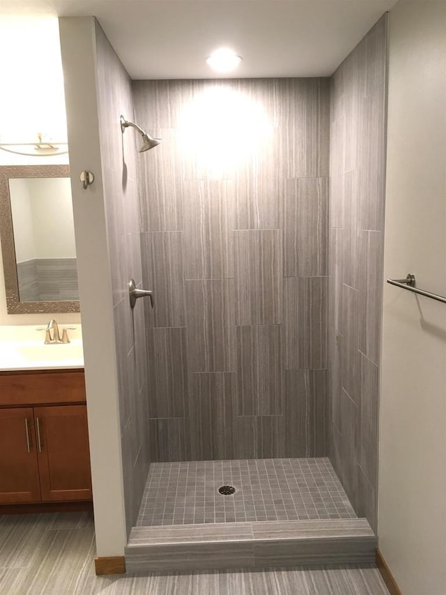 bathroom with vanity and tiled shower