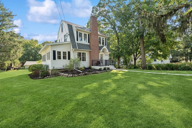 rear view of house with a lawn