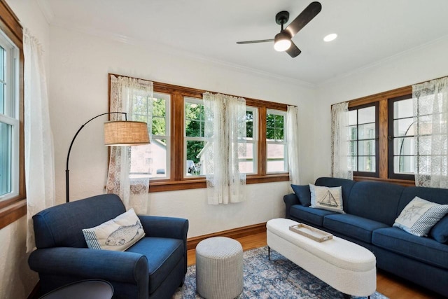 living room with ceiling fan, ornamental molding, and hardwood / wood-style floors