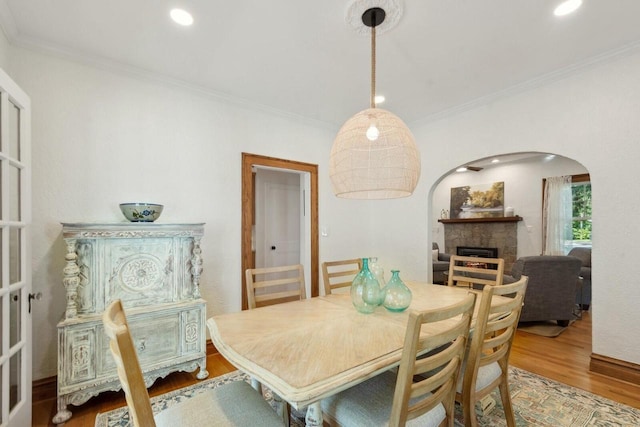 dining area featuring crown molding and hardwood / wood-style floors