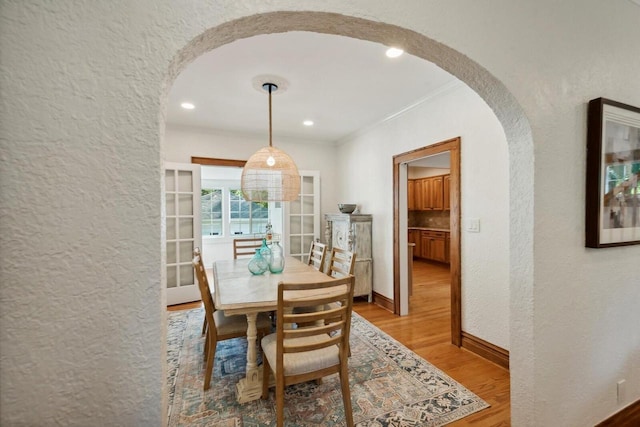 dining room featuring crown molding and wood-type flooring