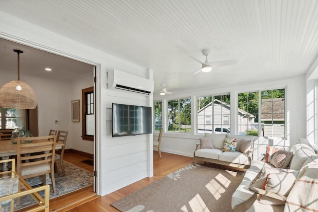 sunroom / solarium with an AC wall unit and ceiling fan