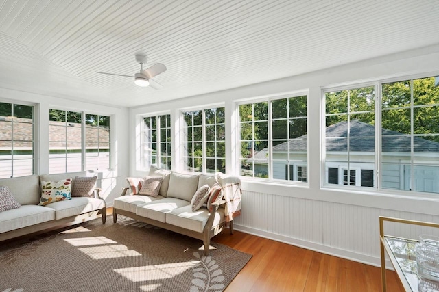 sunroom / solarium featuring ceiling fan