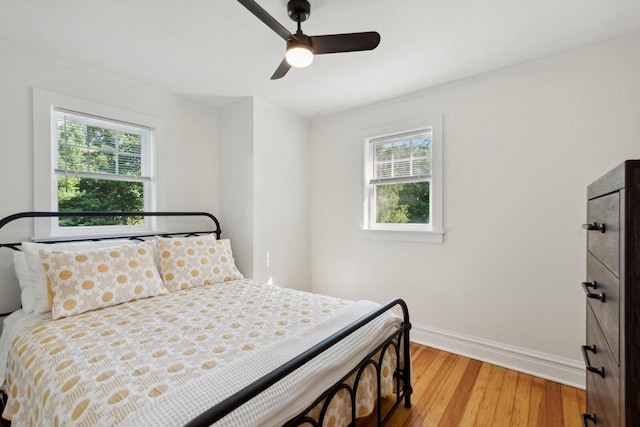 bedroom featuring multiple windows, ceiling fan, and light hardwood / wood-style floors