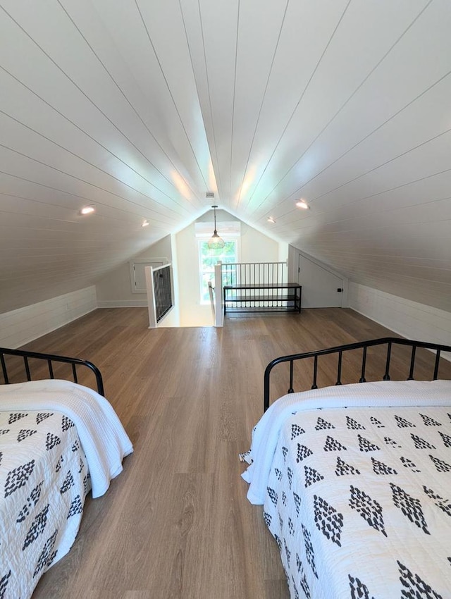 bedroom featuring lofted ceiling and wood-type flooring