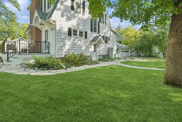 view of side of property with a yard