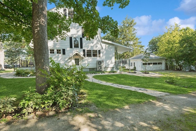 view of front facade with a garage, an outdoor structure, and a front yard