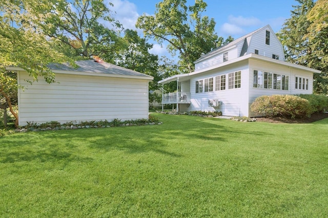 rear view of house featuring a yard