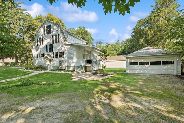 view of home's exterior with an outbuilding, a yard, a garage, and a porch