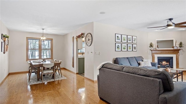 living room featuring ceiling fan and light hardwood / wood-style flooring