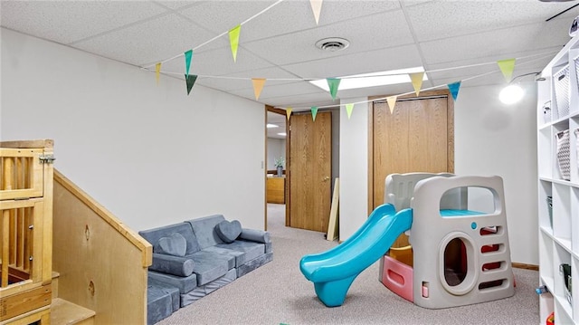 interior space with light carpet and a paneled ceiling